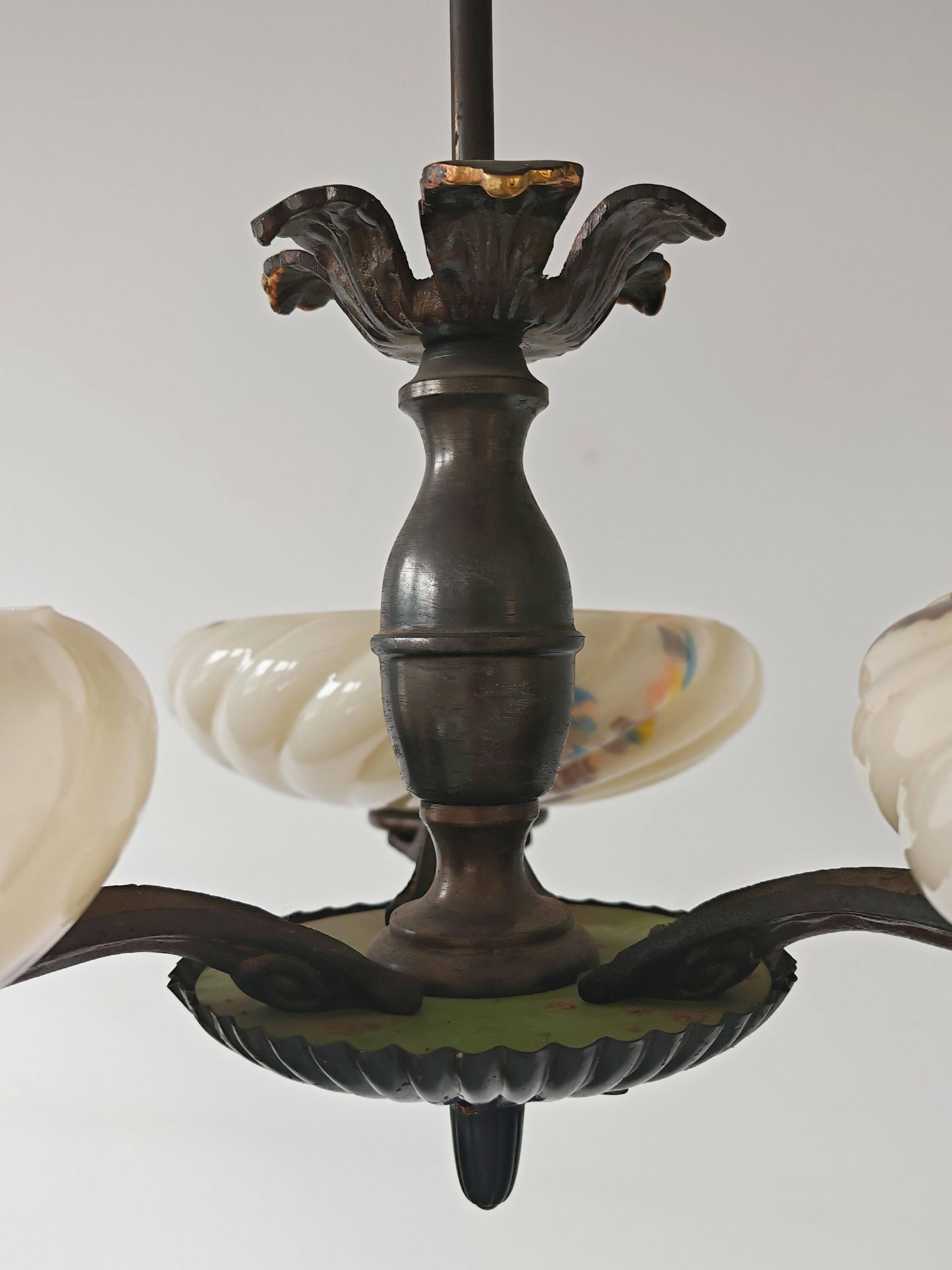 Art Deco bronze three-arm chandelier with marbled glass shades.