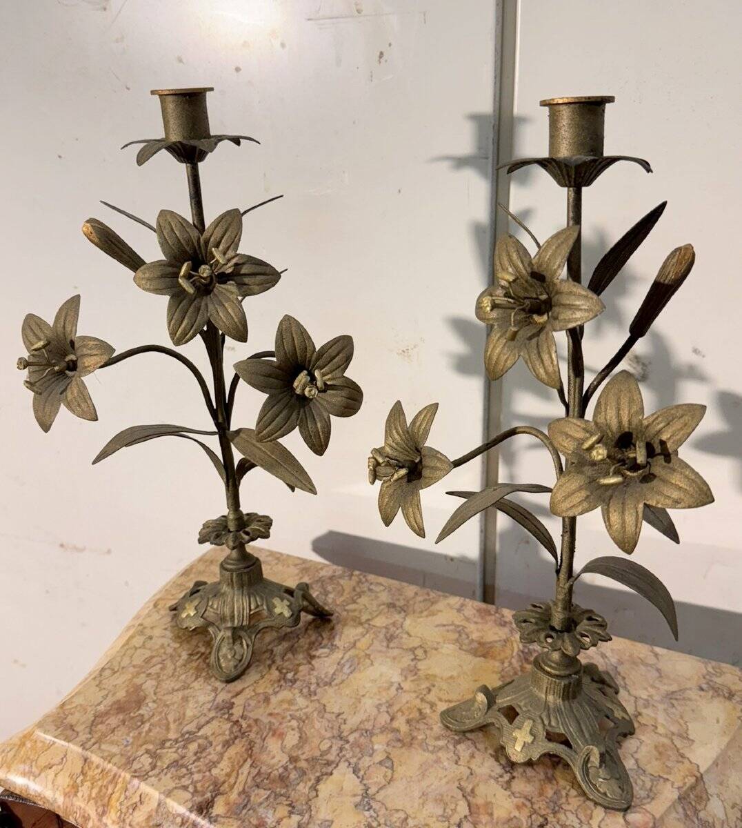 Pair of church candlesticks in bronze with floral decorations.