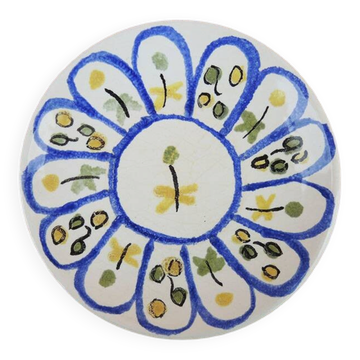 Old ceramic saucer decorated with hand-painted flowers.