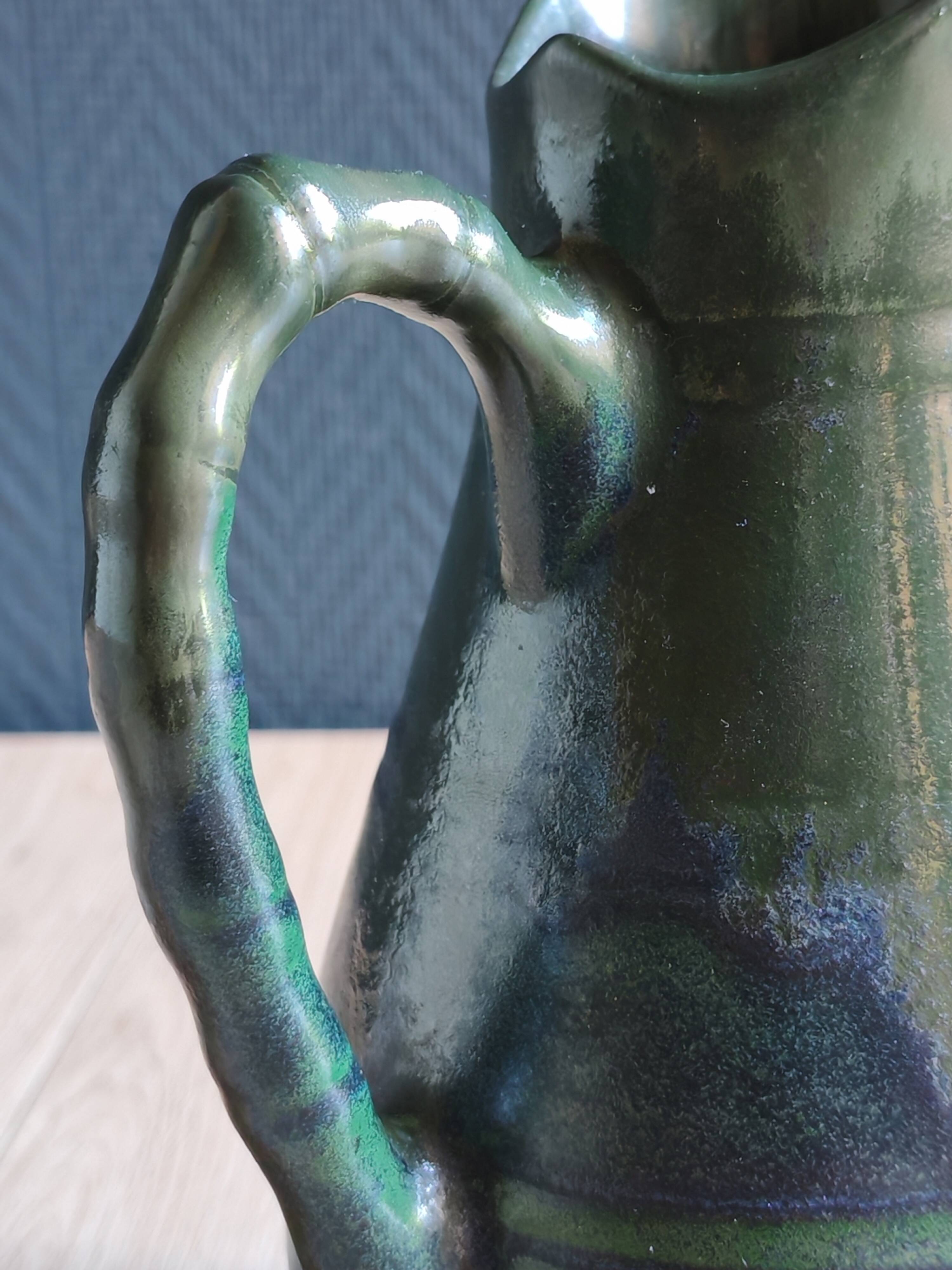 Vintage ceramic pitcher vase in glazed green and blue.