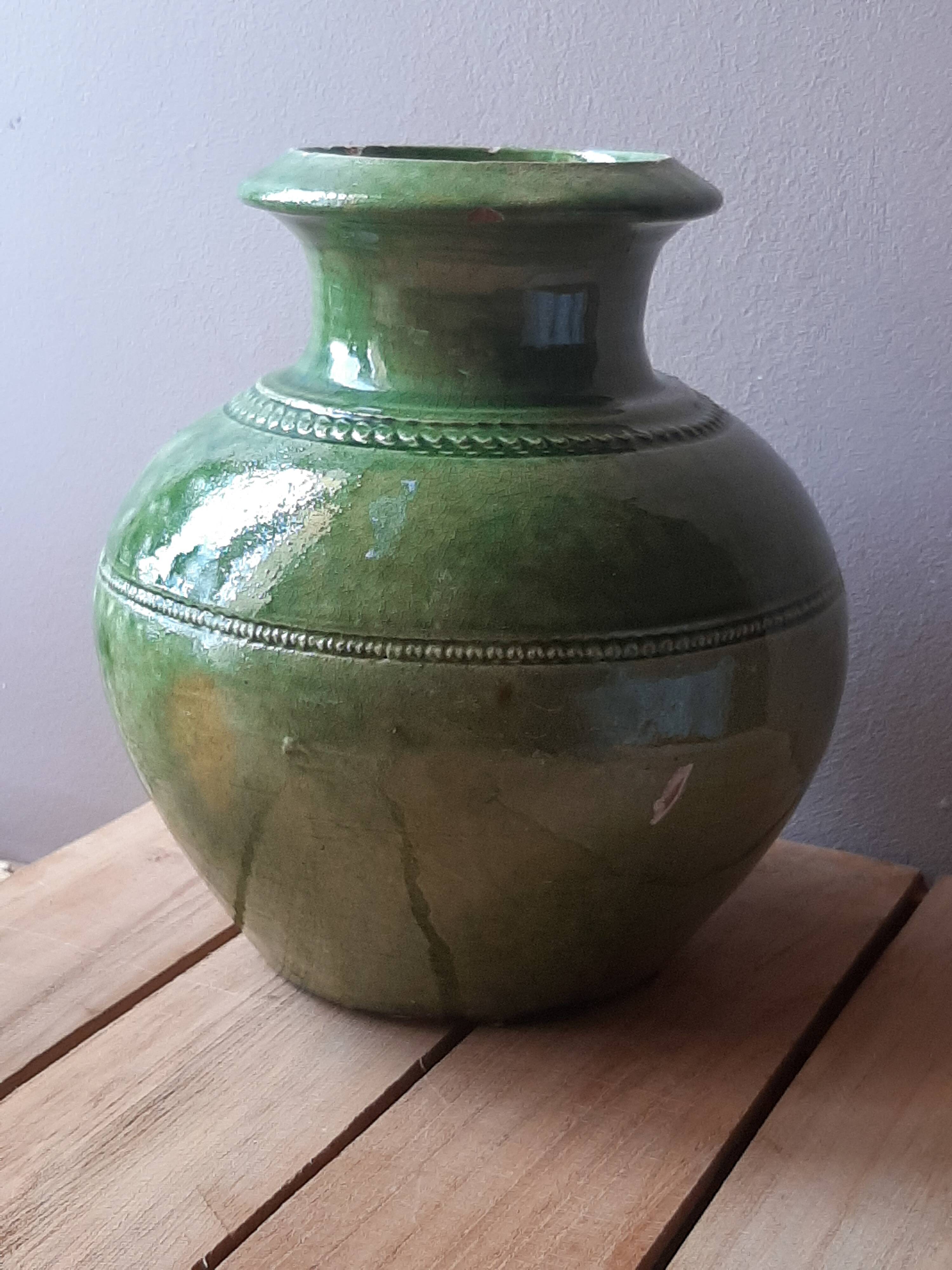 Ancient vase in glazed terracotta with green glaze.
