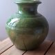 Ancient vase in glazed terracotta with green glaze.
