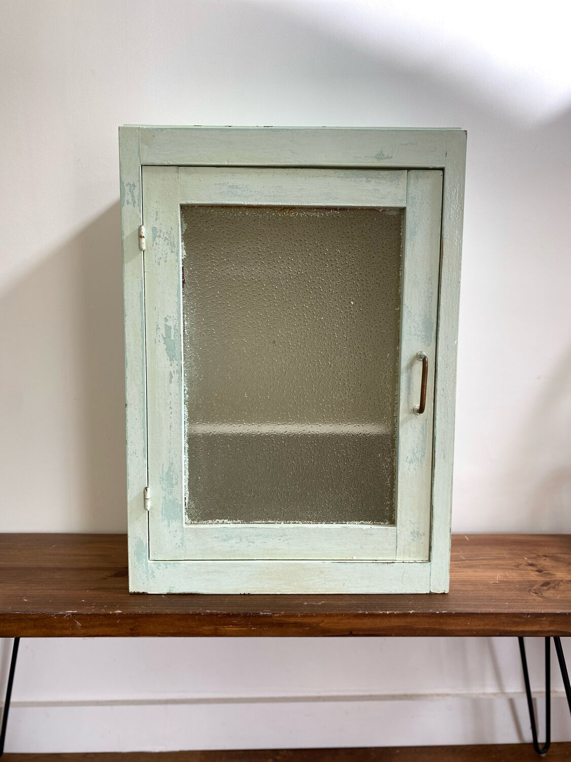 Old medicine cabinet in mint green patinated wood