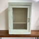 Old medicine cabinet in mint green patinated wood
