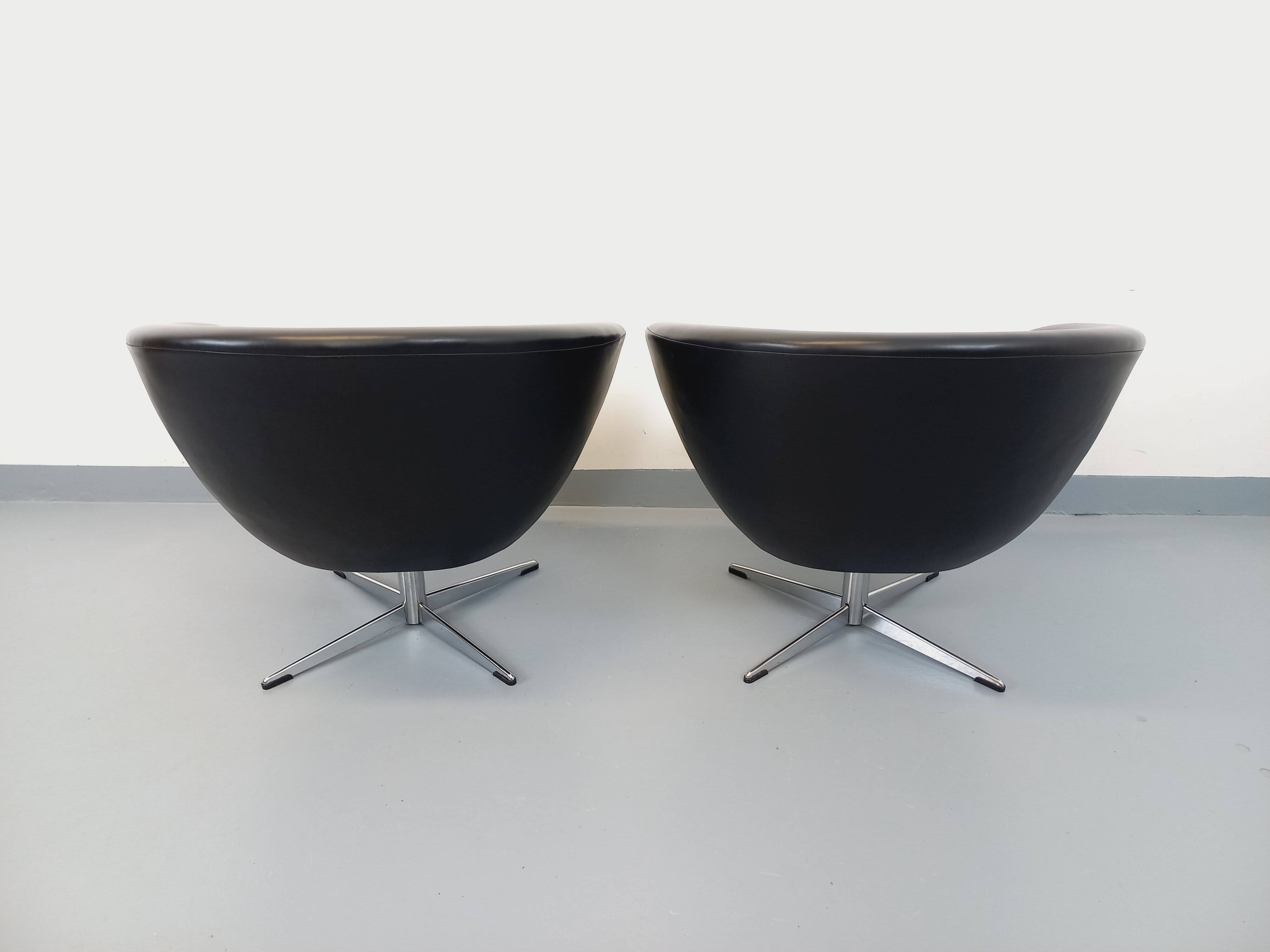 Pair of vintage Scandinavian swivel armchairs in faux leather and chrome.