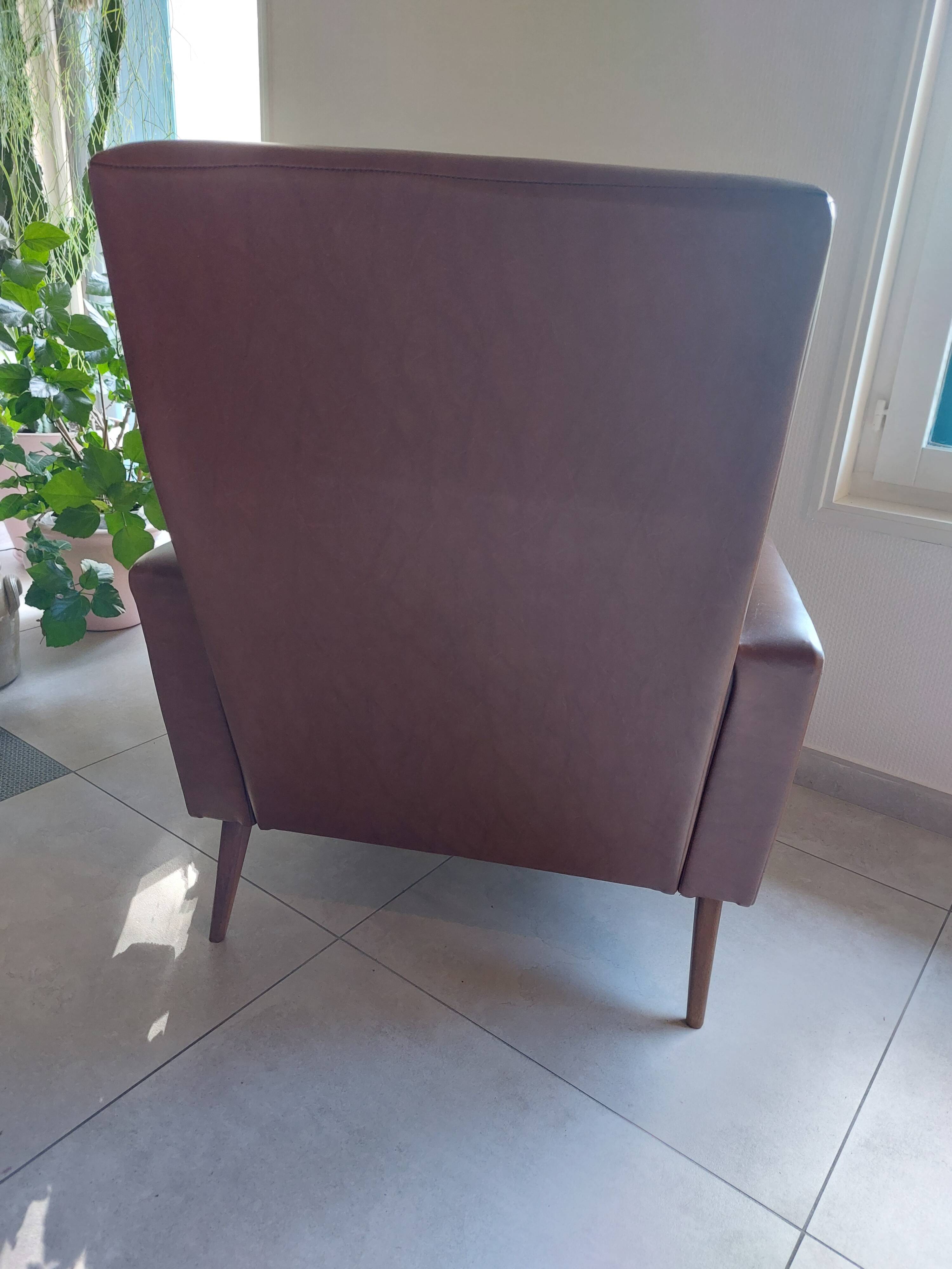 a pair of comfortable vintage armchairs with splayed legs