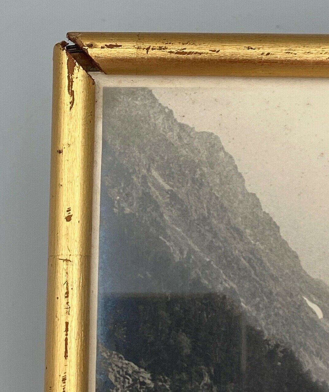 Photo in black and white mountain lake in golden frame