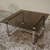 Table basse Roche Bobois 1970 verre fumé piètement en métal chromé.