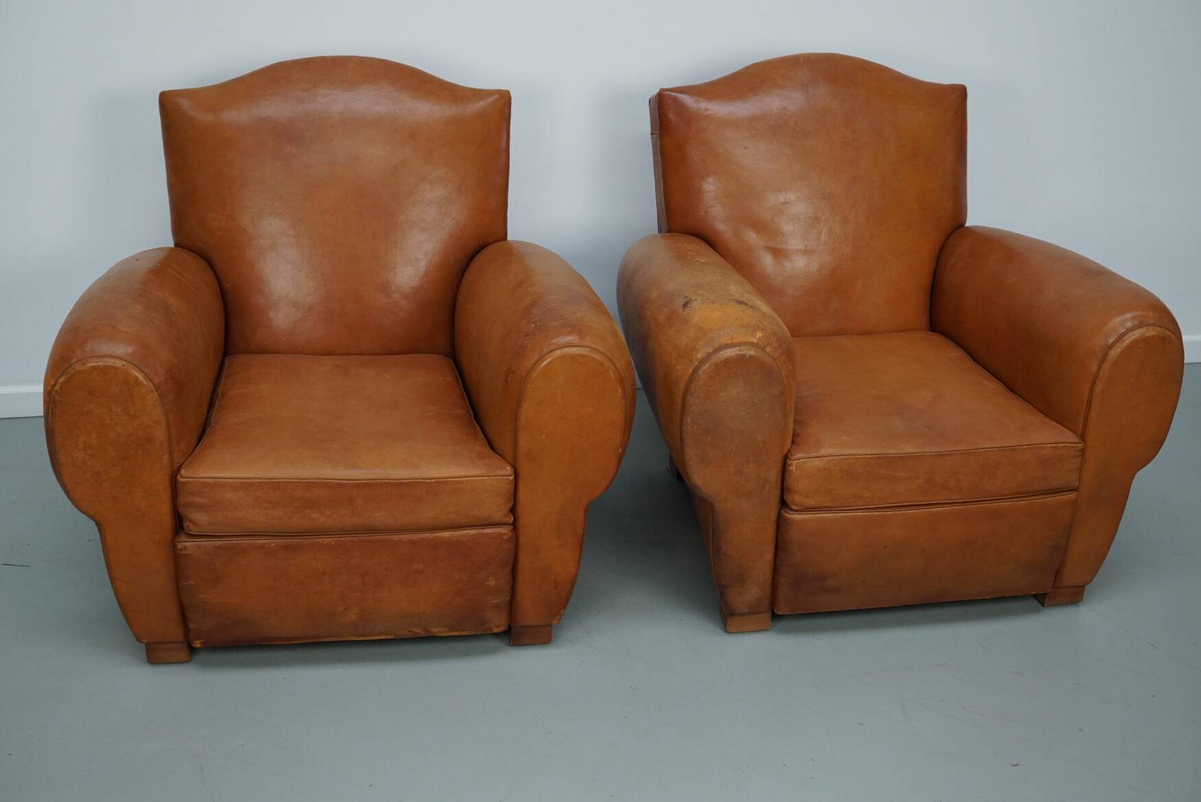 Pair of French club chairs with moustache back in cognac leather, 1950s