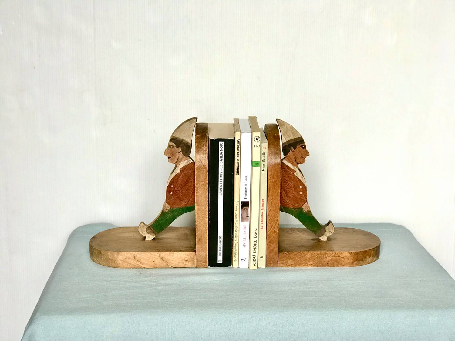 Old wooden bookends with painted characters