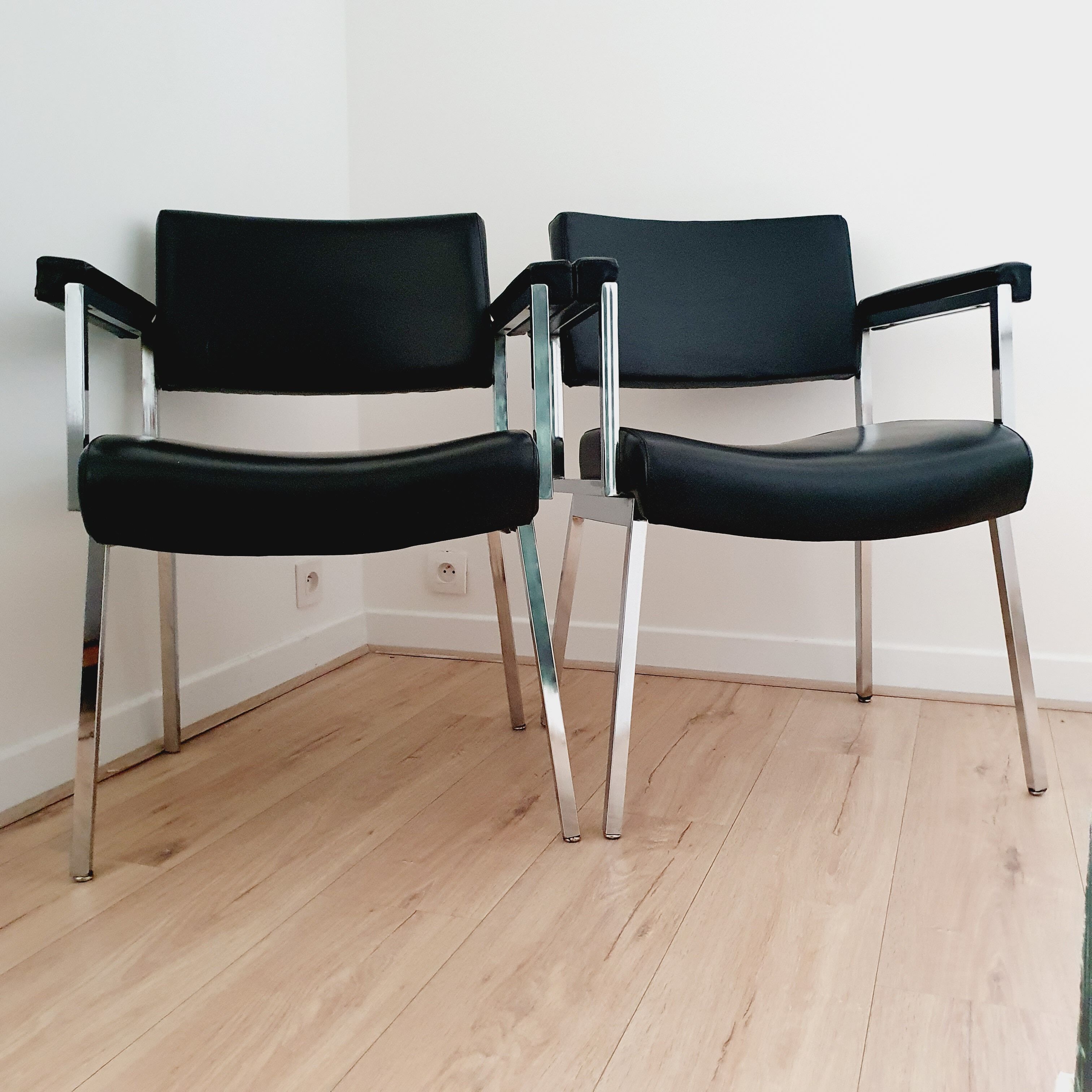 Pair of black skaï and chrome armchairs