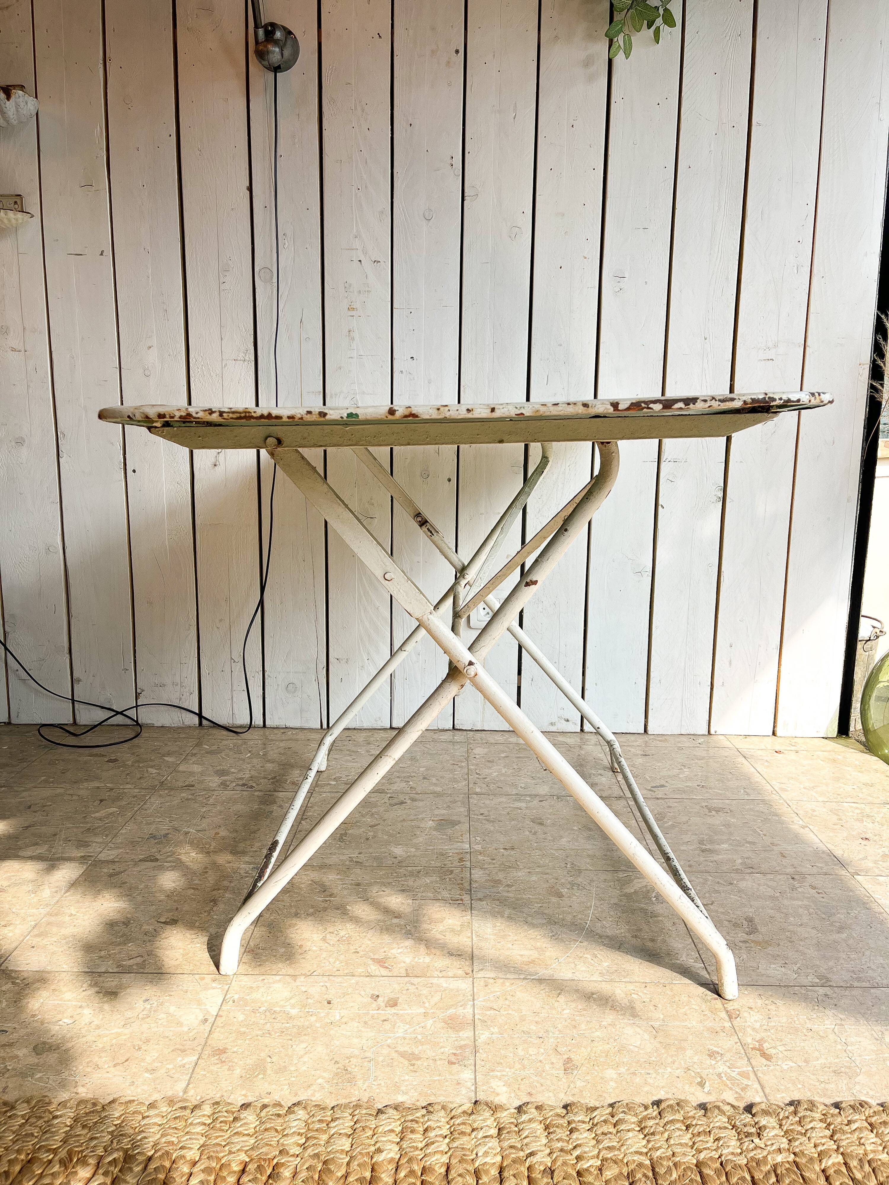White folding metal bistro table