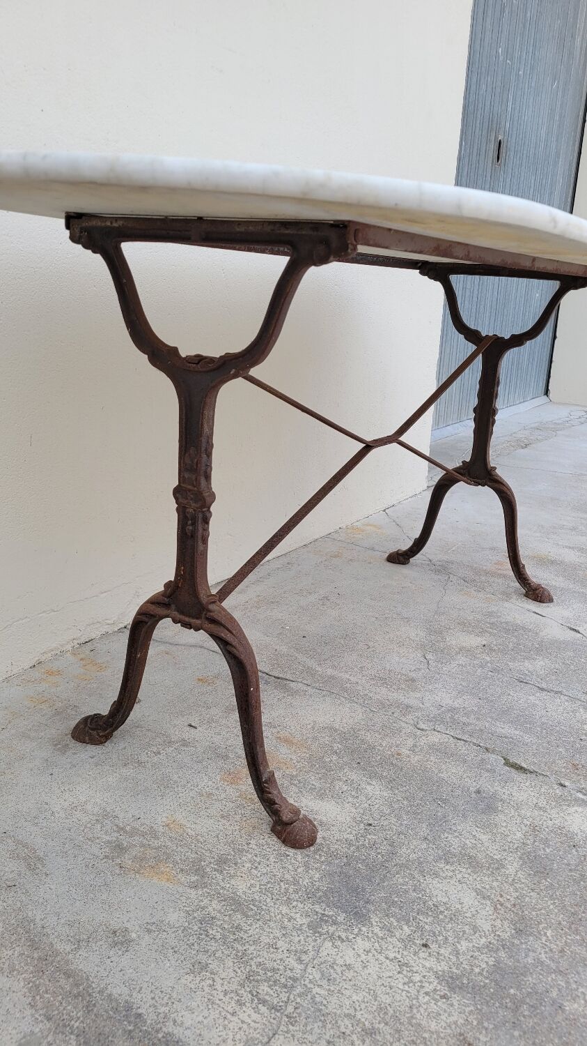Restaurant bistro table in oval marble and decorated cast iron bases -1m51