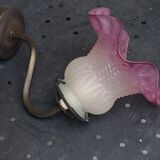 Metal wall lamp with frosted glass shade in the shape of a pink corolla