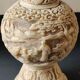Asian-inspired ball vase. In beige cinnabar lacquer. Scenes of life decor. Arabesque and floral friezes. Height 24 cm