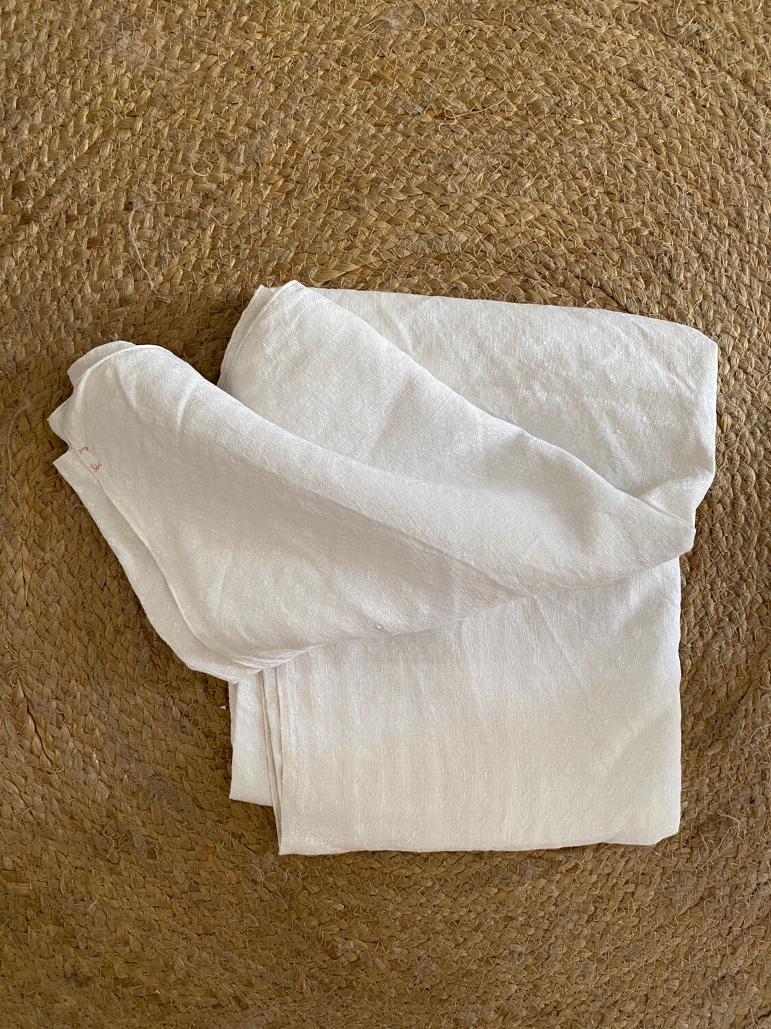 Old white cotton tablecloth.