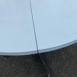 White dining table with a central pedestal, extendable, from the 1970s.