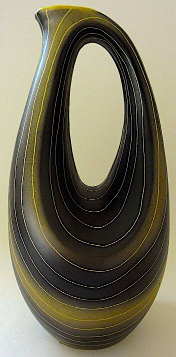 Earthenware vase decorated with yellow lines on a black and yellow background