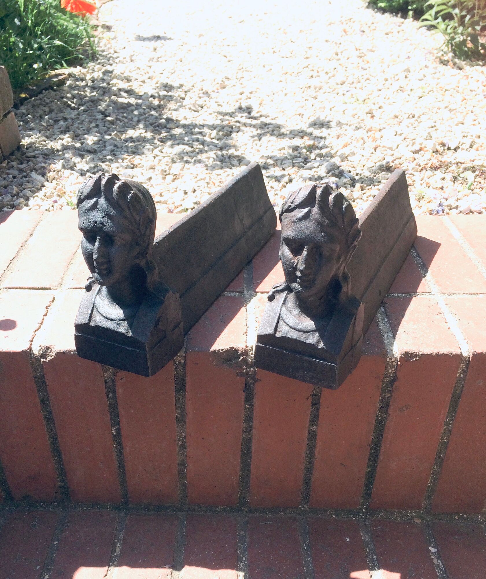 Pair of cast-iron chenet characters with laurels