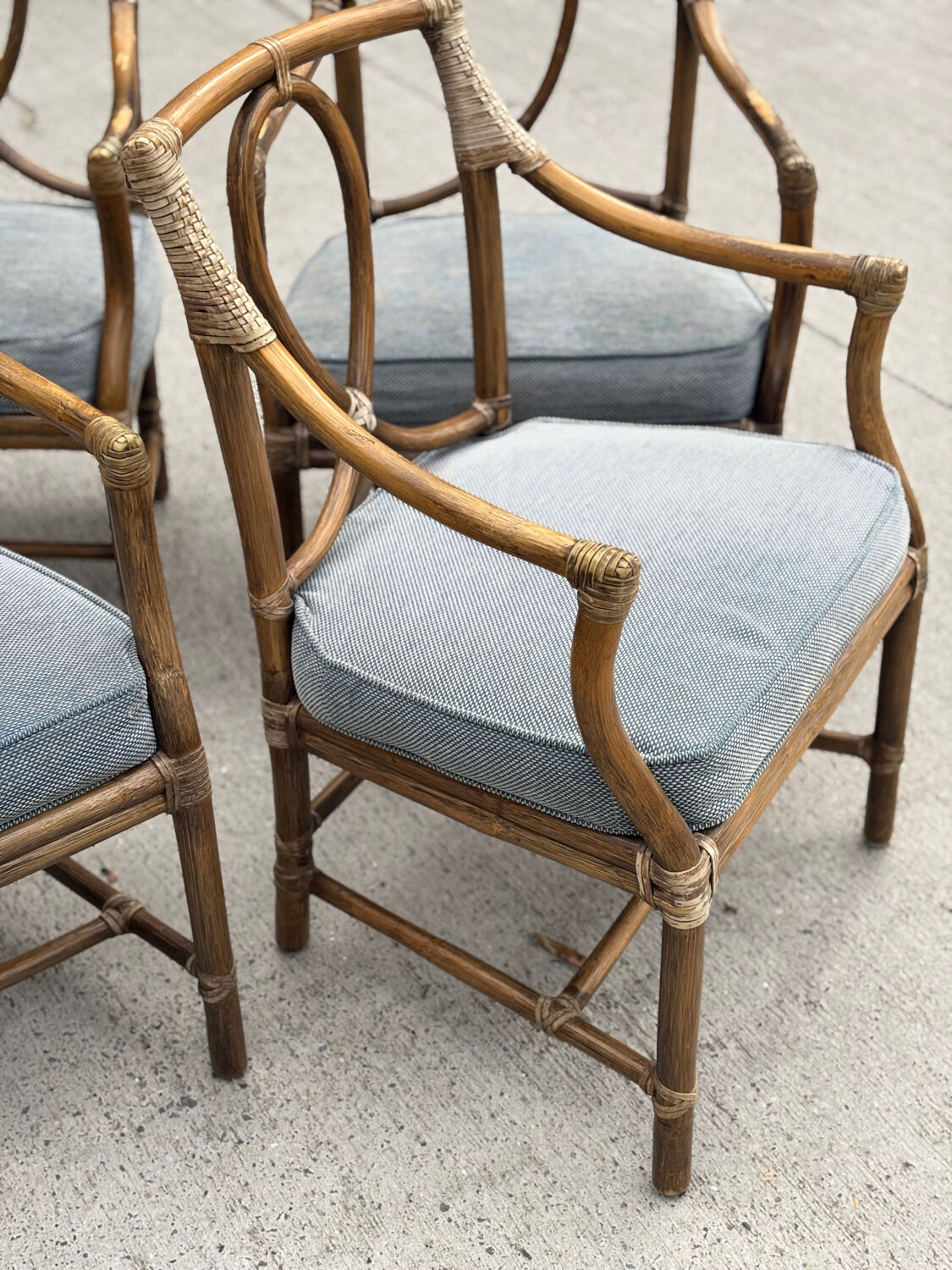 Set of 4 vintage McGuire rattan chairs with cushions.