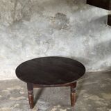 Coffee table, round antique Indonesian teak table with straight legs.