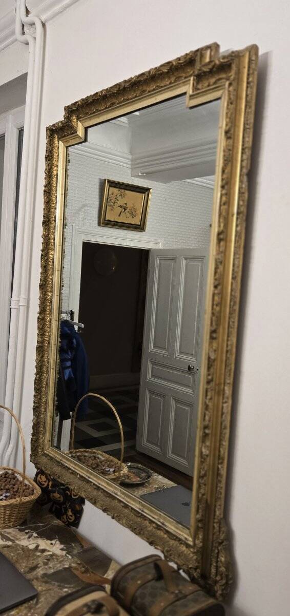 Large antique mirror from the Napoléon III era, finely carved and gilded with gold leaf.