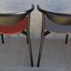 4 gondola-style chairs with a sturdy metal frame and faux leather.