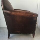 Club armchair in studded leather - early twentieth century