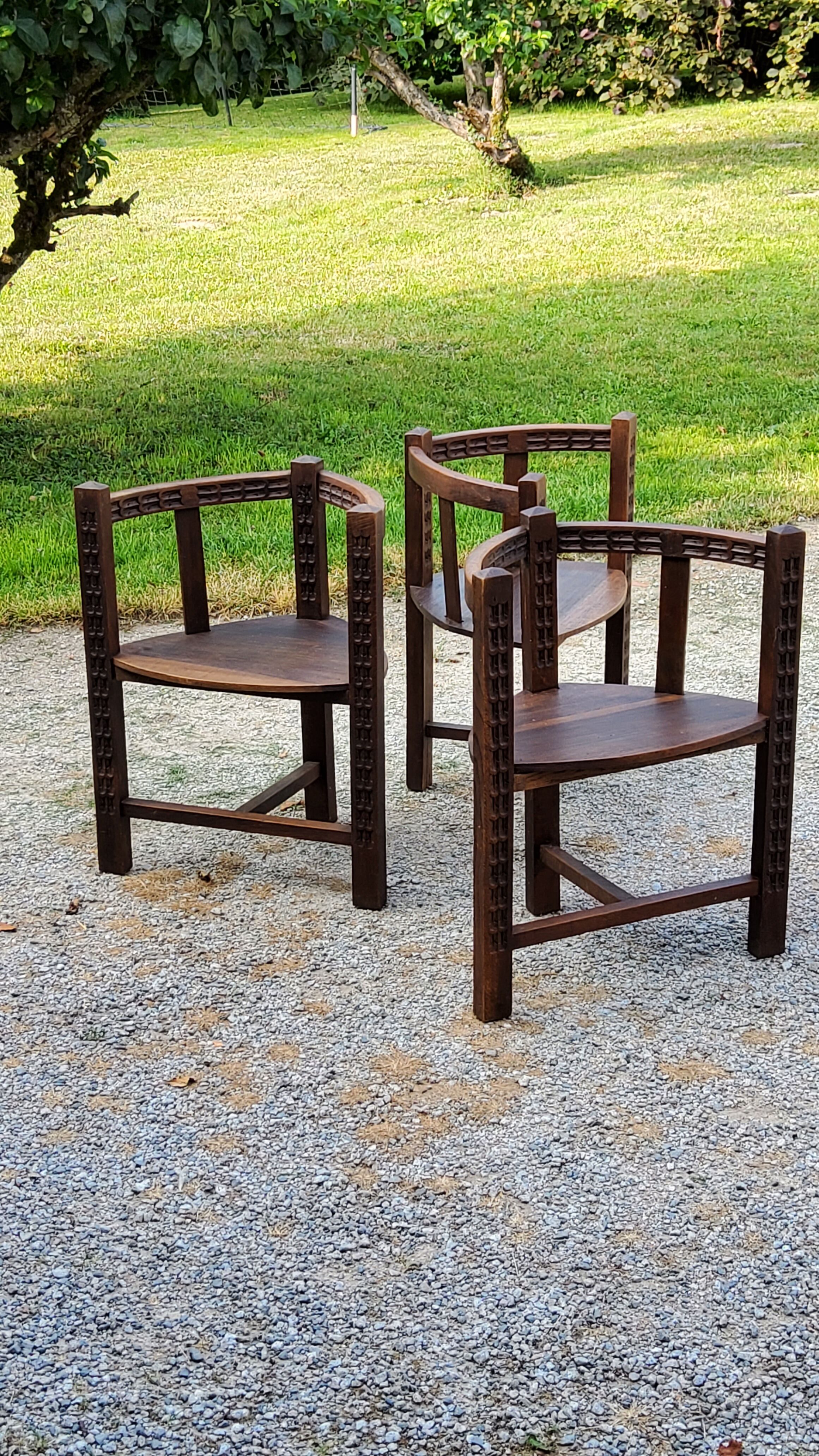 Set of three brutalist tripod armchairs in carved solid oak