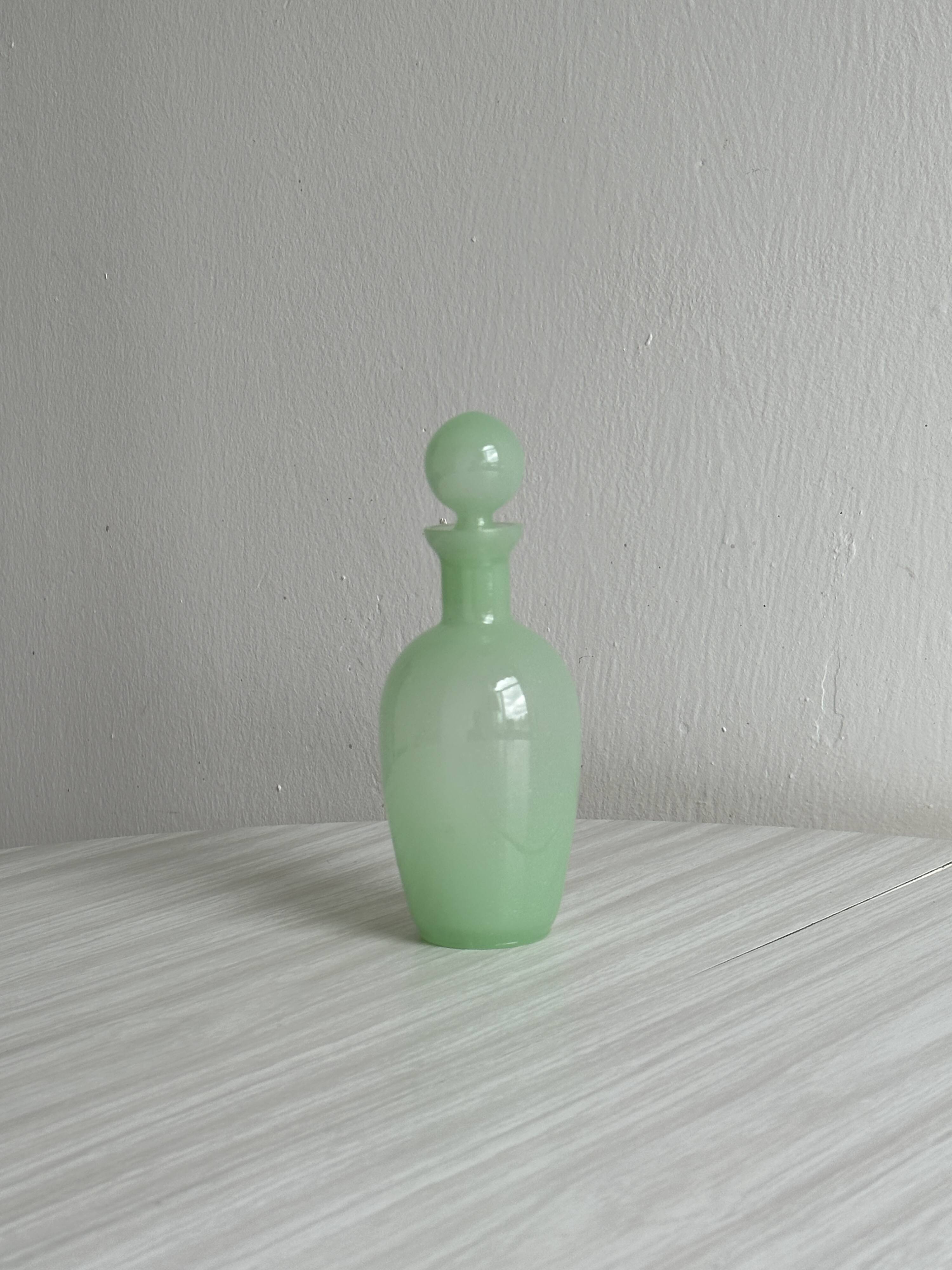 Opaque light green glass vial