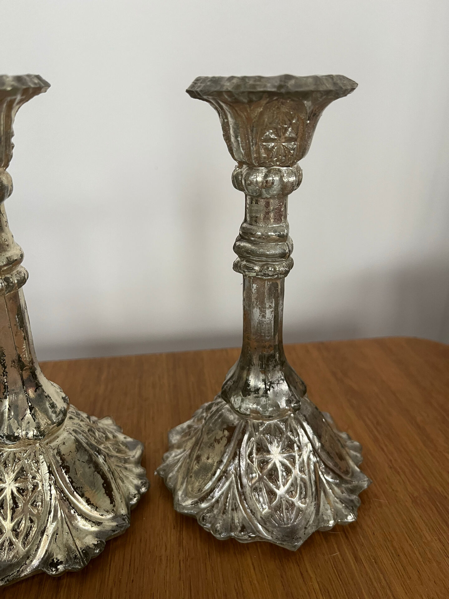 Pair of pressed glass candlesticks with silver plating.