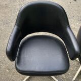 Pair of vintage armchairs in black skai with metal legs.