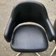 Pair of vintage armchairs in black skai with metal legs.