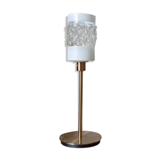 Table lamp with gold metal base and cylindrical textured glass shade