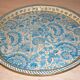 Blue cashmere round tray on white background.