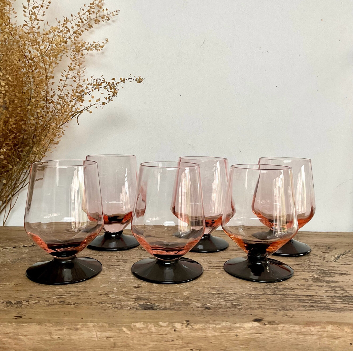 6 small pink glasses with black stems
