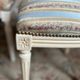 Pair of Louis XVI style chairs in painted wood and satin, classic elegance.
