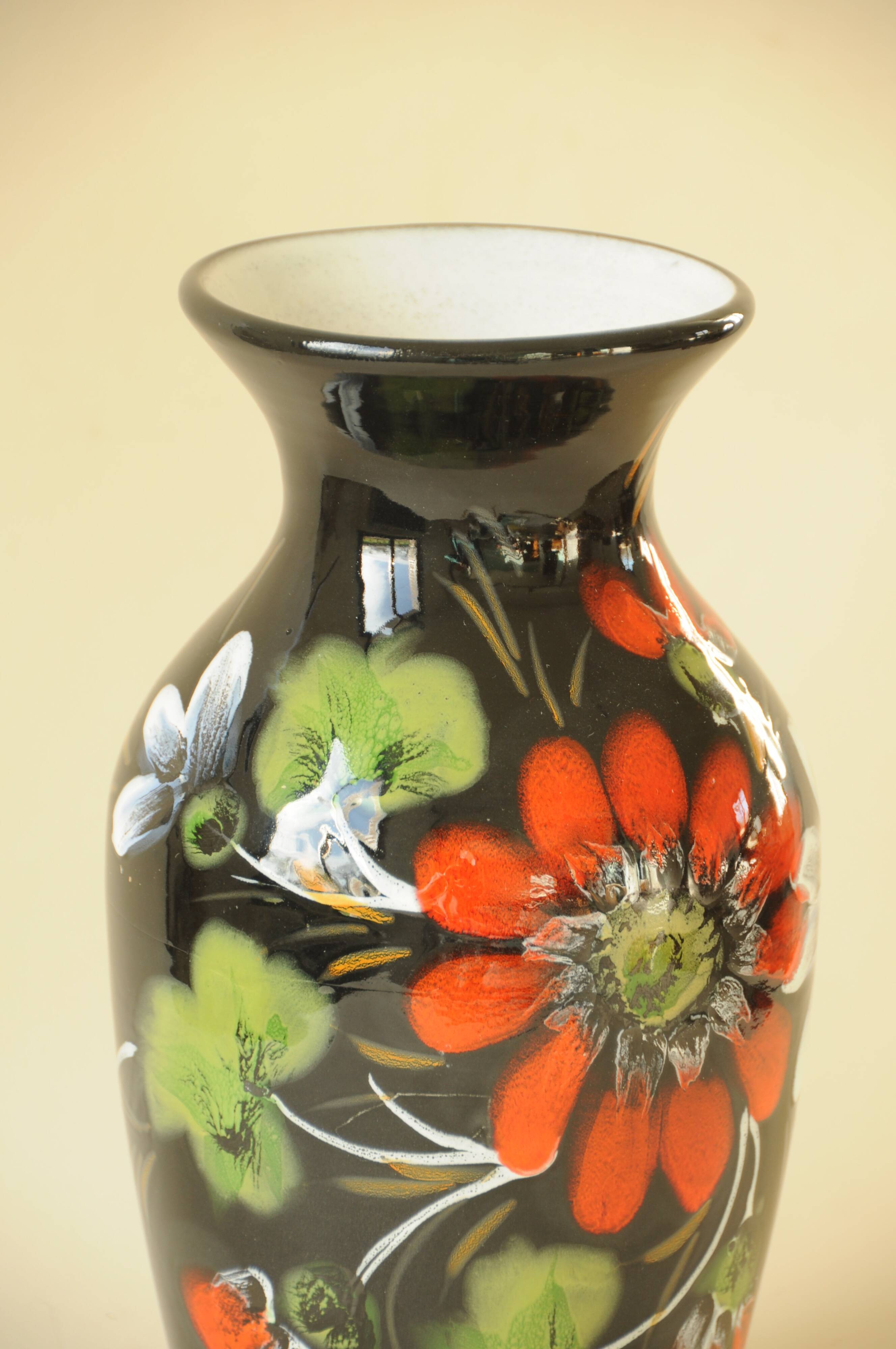 Vintage black ceramic vase with painted floral decoration – stylised colourful flowers.