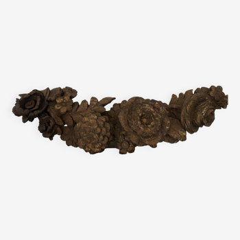 Old decorative frieze, wooden pediment carved with vintage carved flowers and foliage