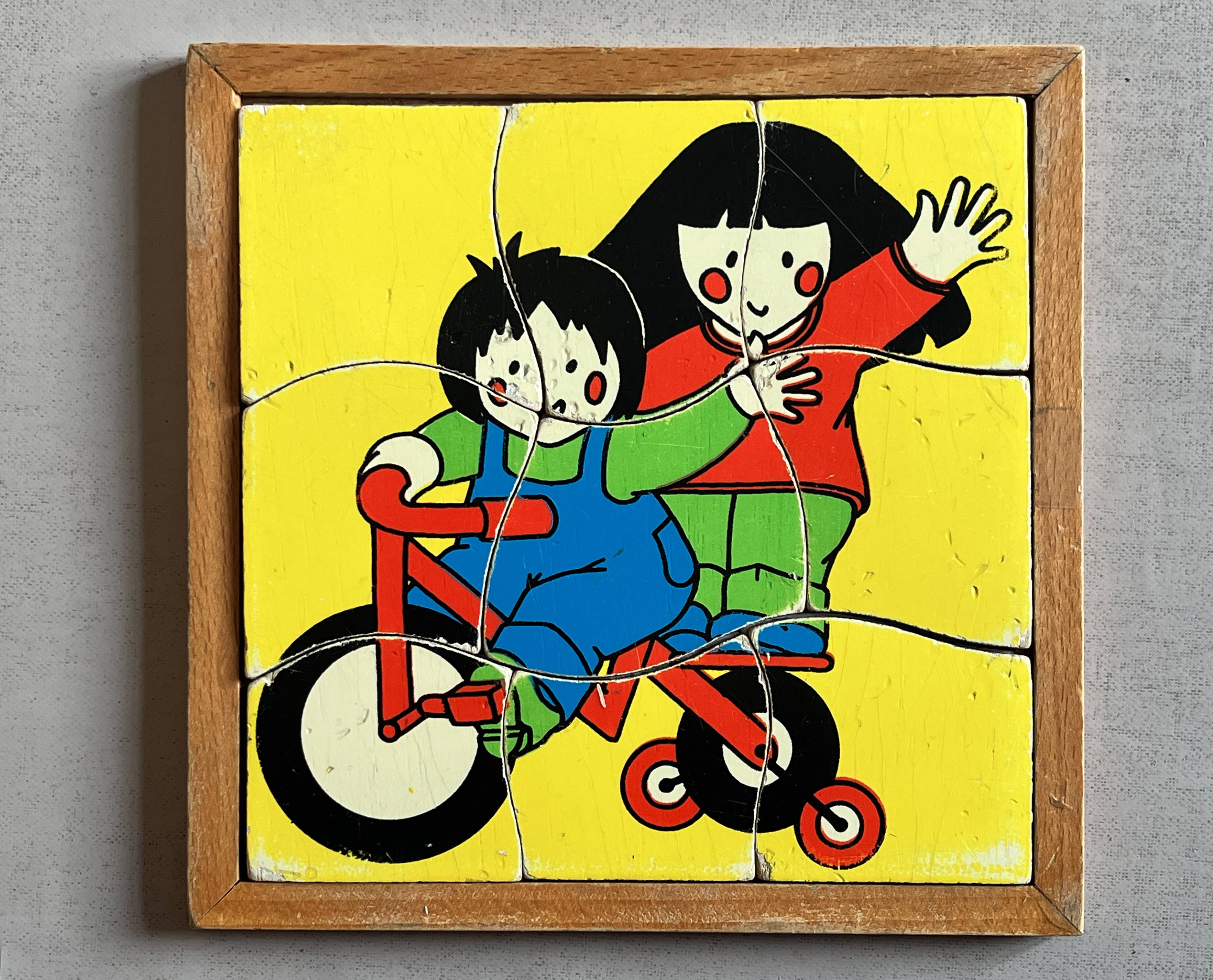 Wooden frame puzzle from the 60s/70s depicting two children on bicycles.