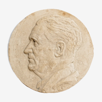 Old plaster medallion, man profile
