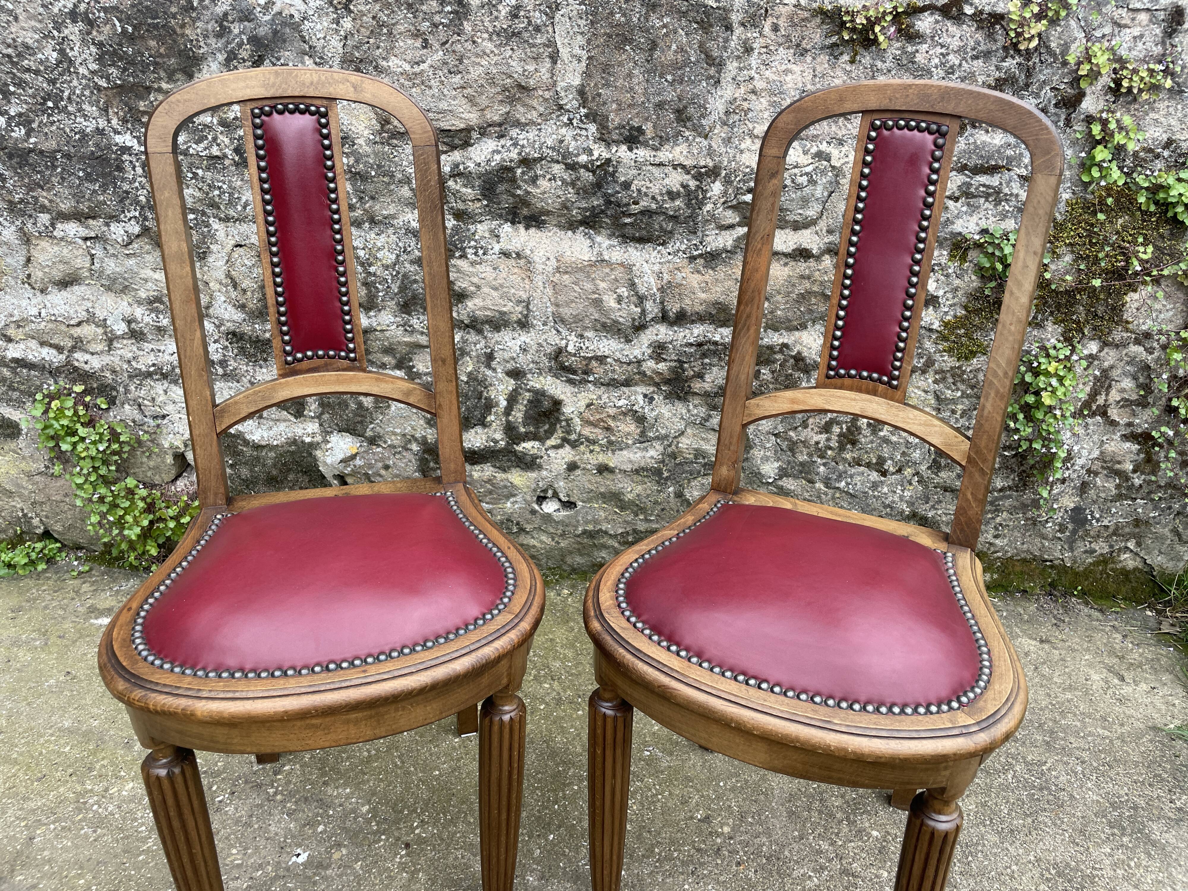 Pair of studded burgundy leather Art Deco chairs