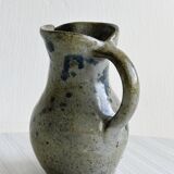 Small handcrafted ceramic pitcher with spotted enamel