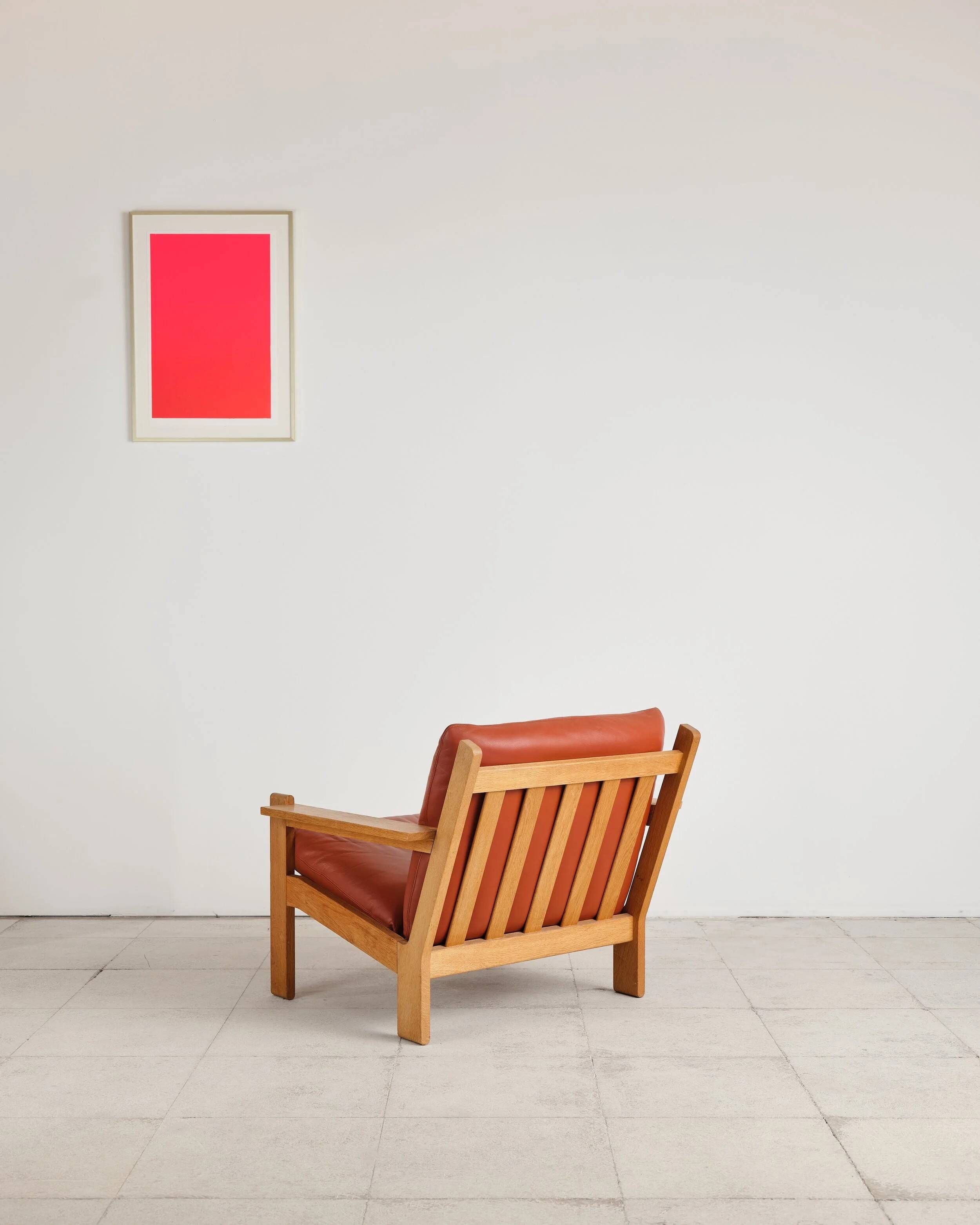 Brutalist armchair in oak and leather by Tage Poulsen, Denmark, 1970s.