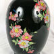 Black opal vase decorated with flowers