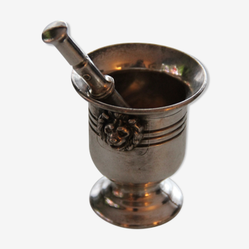 Mortar and silver metal pestle, lion heads