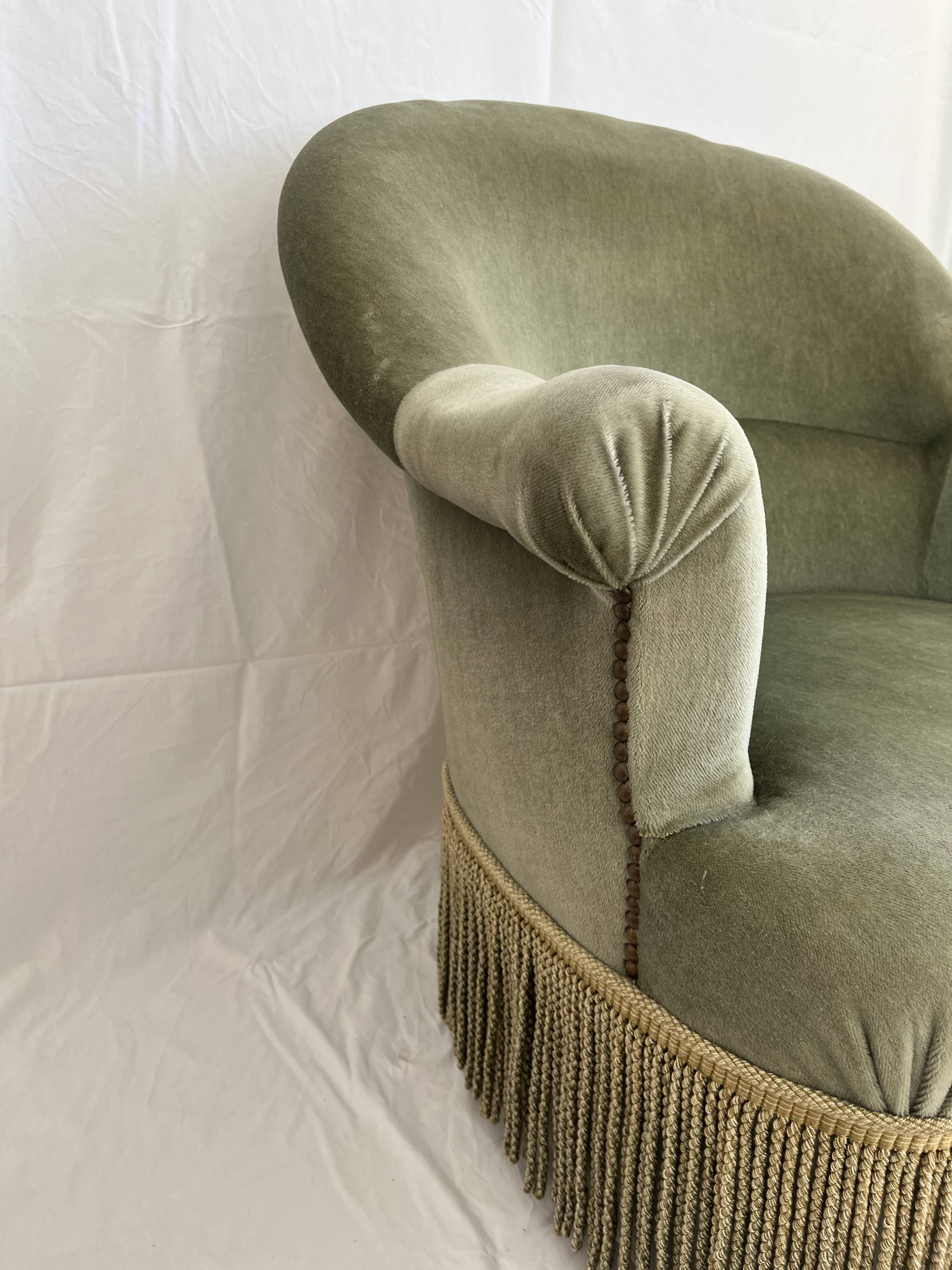 sage green toad armchairs with gold fringe