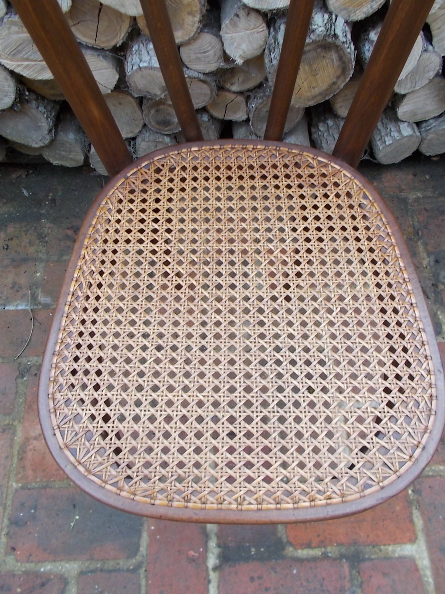 Curved wooden bistro chair with caning