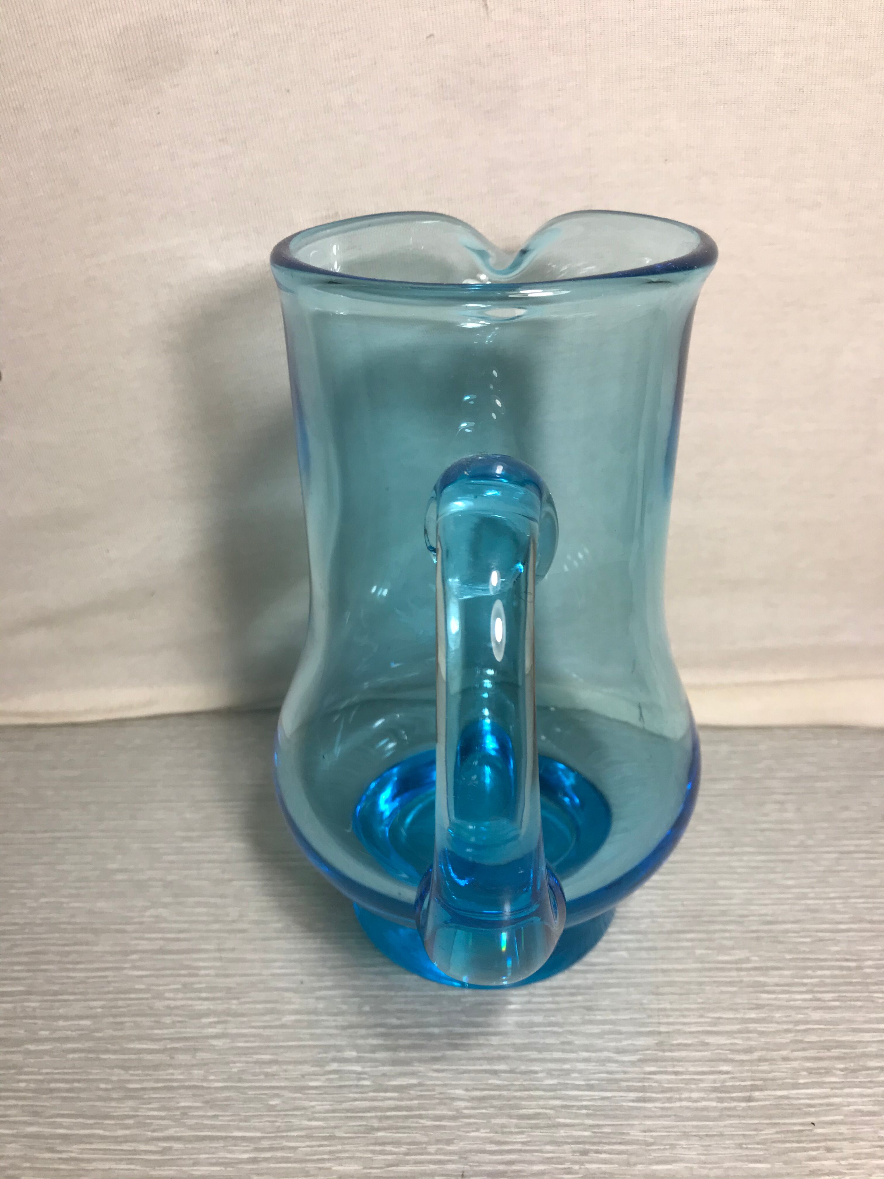 Old blue blown glass pitcher with vintage handle