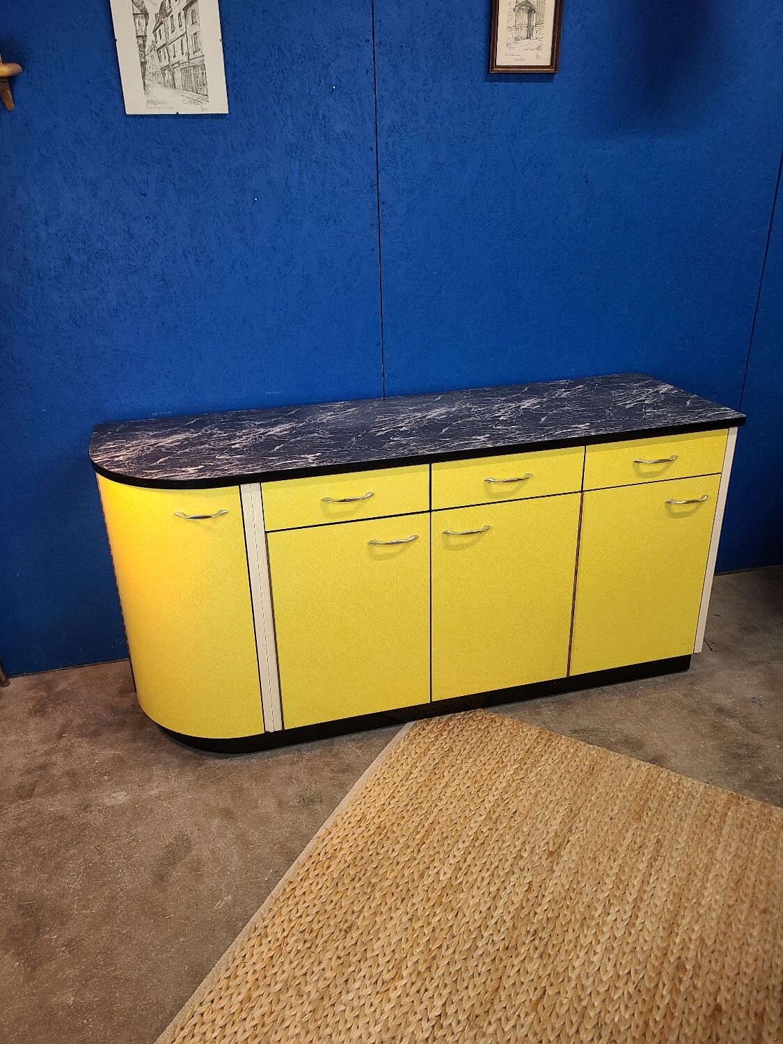 Vintage yellow sideboard, and black marble top.